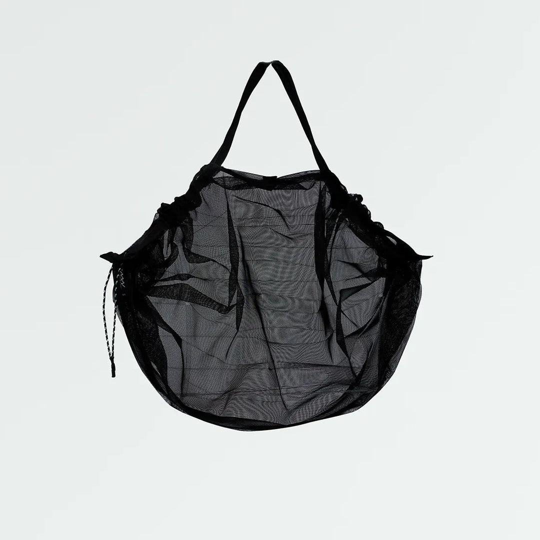 Black mesh bag on a light gray background