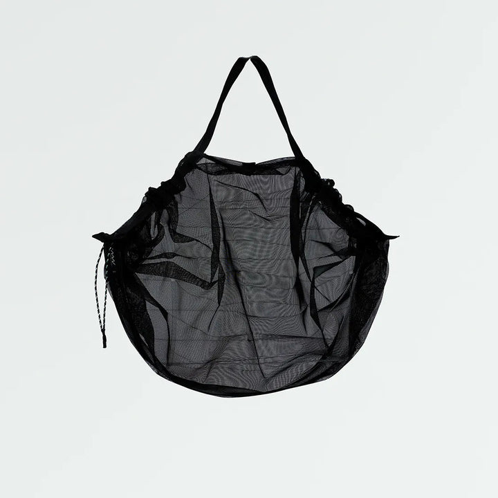 Black mesh bag on a light gray background