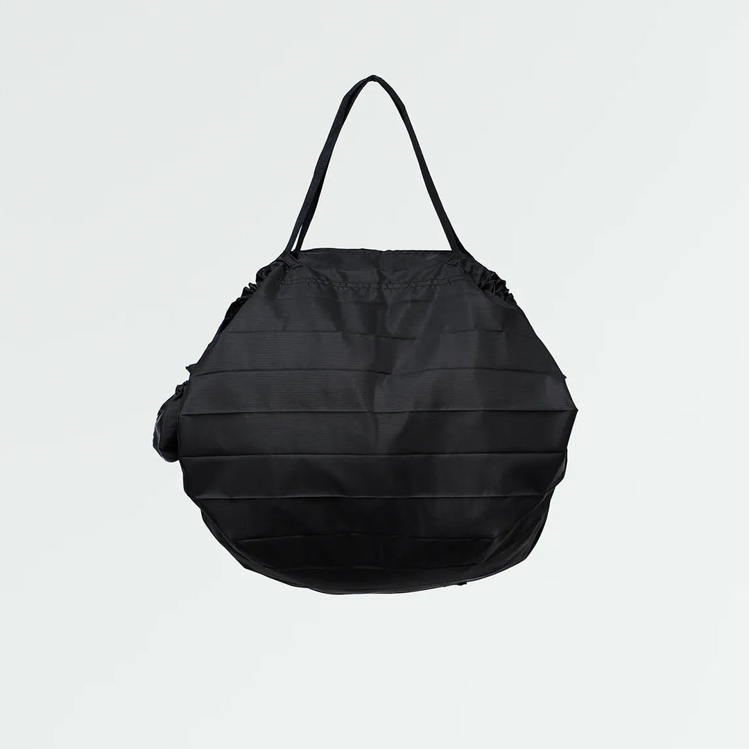 Black pleated bag on a light gray background
