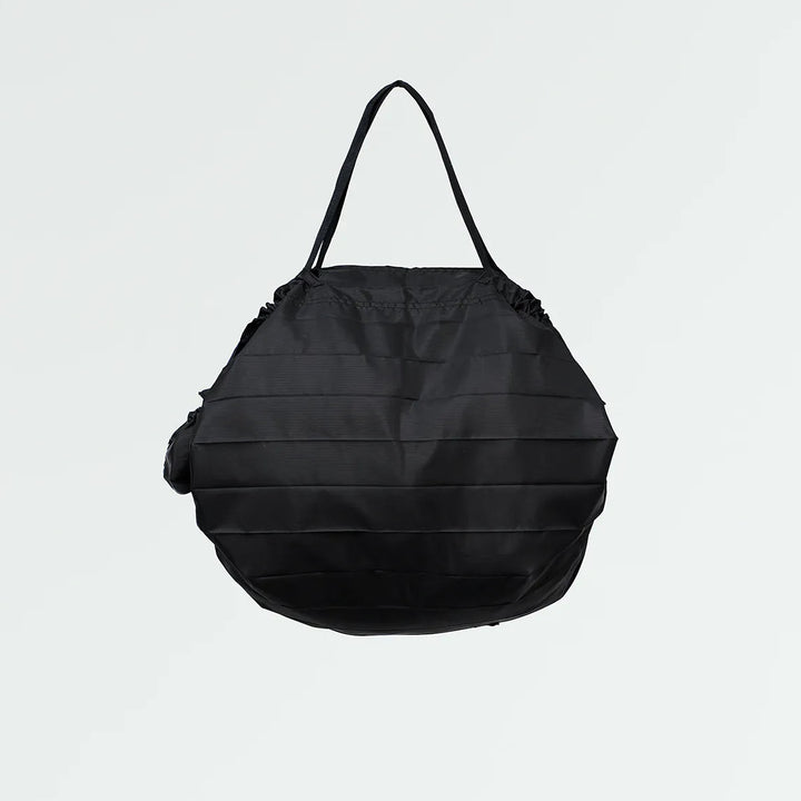Black pleated bag on a light gray background