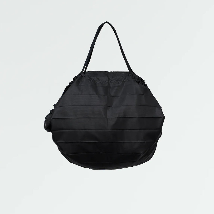 Black pleated bag on a light gray background