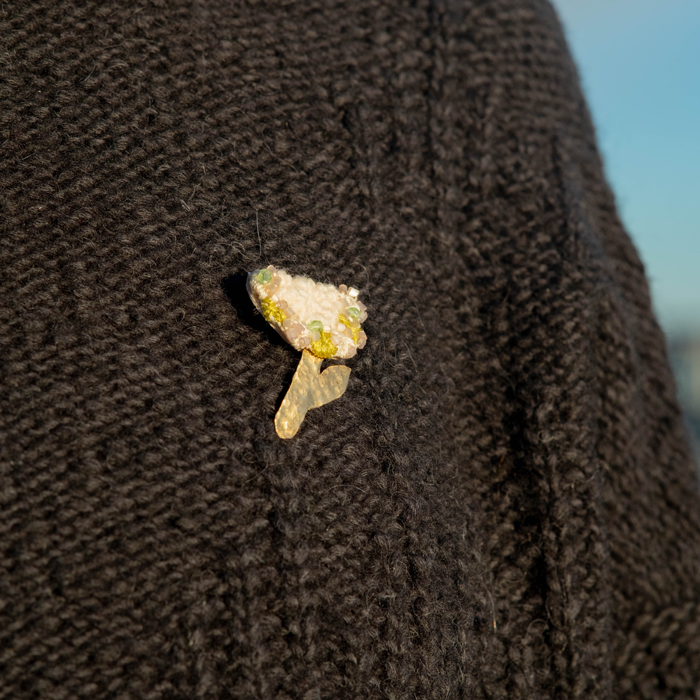 A handmade hydrangea brooch pinned on a jumper