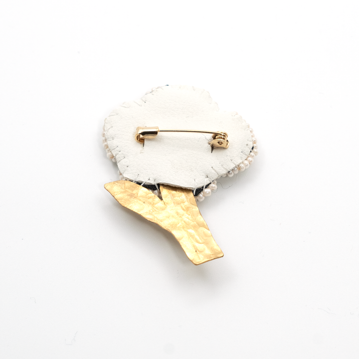 The back of the handmade white flower brooch