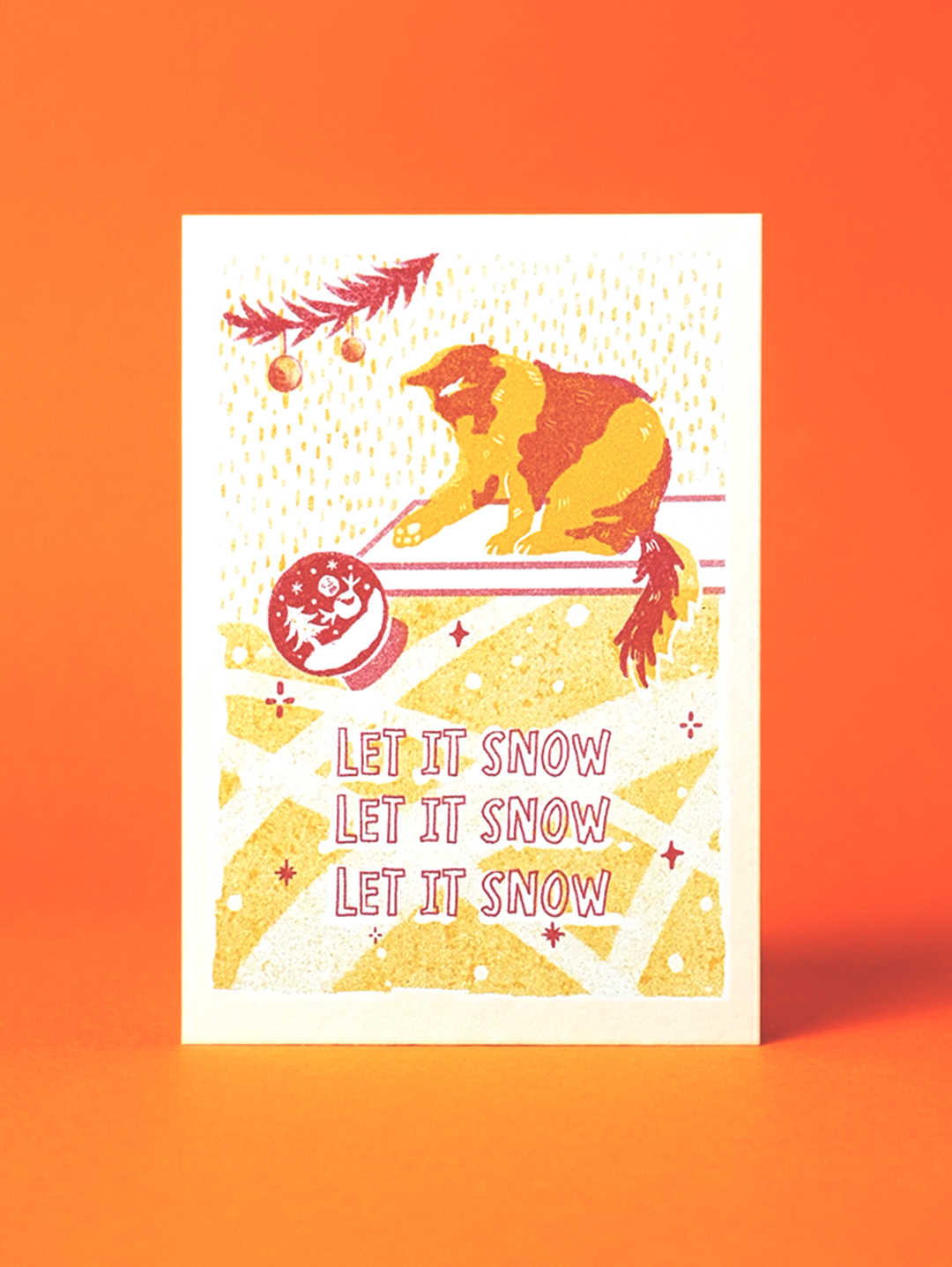 Card with a bear skiing and 'Let it snow' text on an orange background