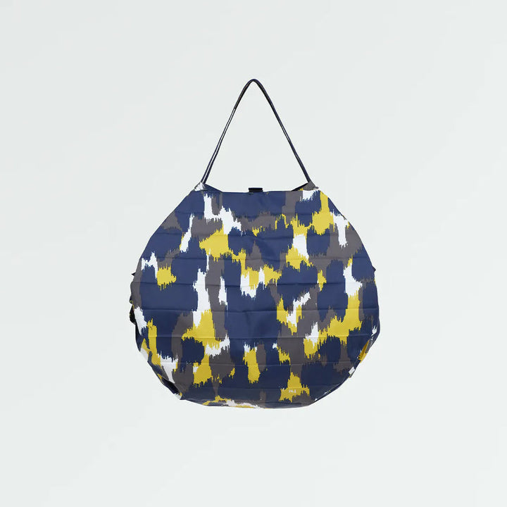Blue and yellow patterned bag on a light gray background