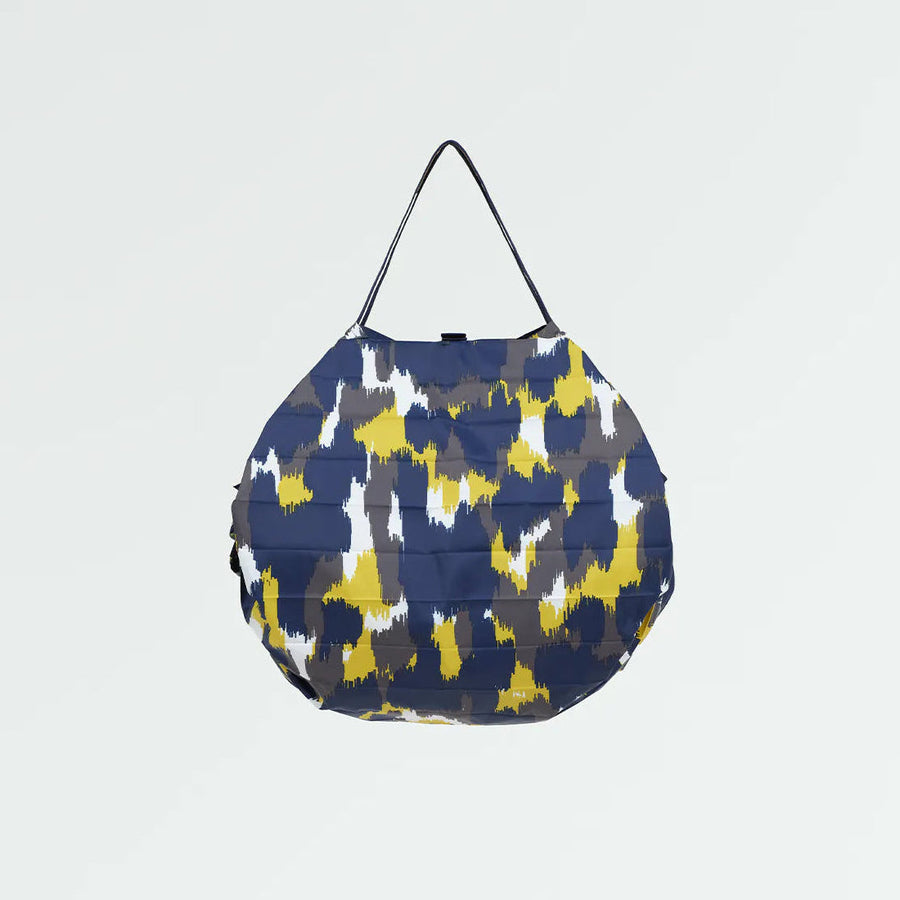 Blue and yellow patterned bag on a light gray background
