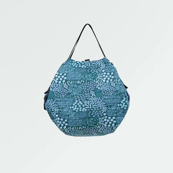 Blue patterned bag on a light gray background