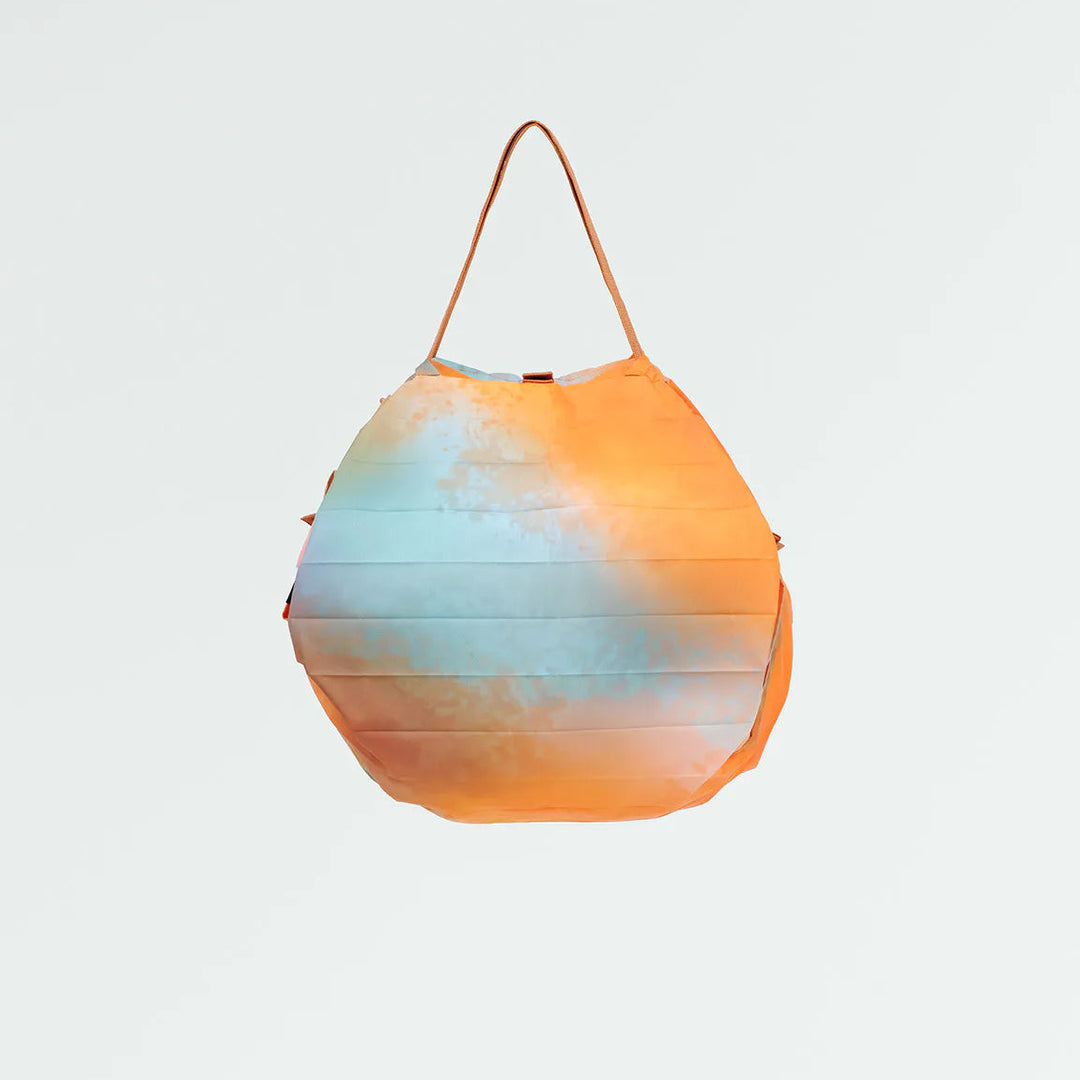 Gradient orange to blue bag on a light gray background